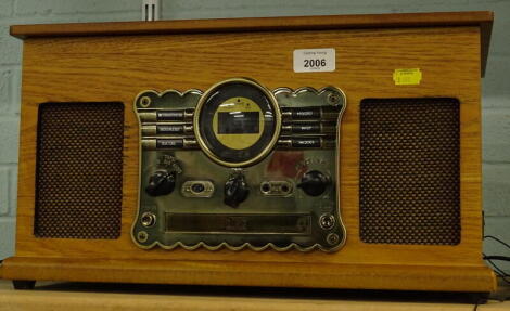 A DAB music centre in wooden case, with auto stop, USB port, CD player turn table, and radio with front speakers.