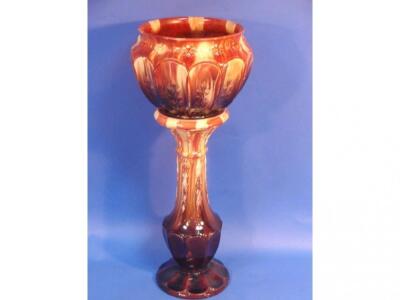 A Victorian brown streak glazed pottery jardiniere and pedestal