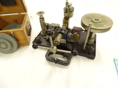 A dead weight calibrator, MK2, with various metal discs, in a fitted case with wooden dove tails, 50cm wide. - 2