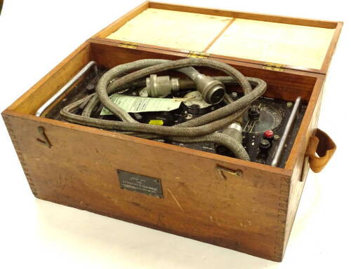 A test set for a TMC type III equipment AMREF 6C/683 SER NOO H15, with table of equipment to the interior of the box, in metal casing and outer wooden box with visible dove tails, 50cm wide.