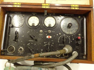 A test set for a TMC type III equipment AMREF 6C/683 SER NOO H15, with table of equipment to the interior of the box, in metal casing and outer wooden box with visible dove tails, 50cm wide. - 2