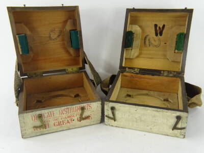 A World War Two pilot's compass box, of square form with visible dovetails, partially marked PS, and another pilot's compass transit box marked P8, each pine with strapping, (2). - 2