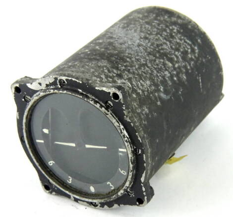 A vintage Artificial Horizon aeroplane dial, in metal casing, as fitted to most World War Two aeroplanes, 12cm diameter.