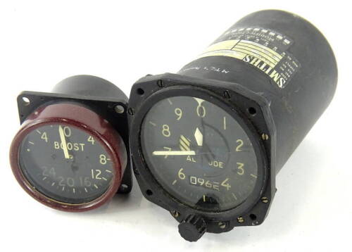 A Smiths vintage aeroplane altitude monitor, in metal casing, with Arabic dial, marked altitude 1504K, 8cm wide, and a further boost dial (2).