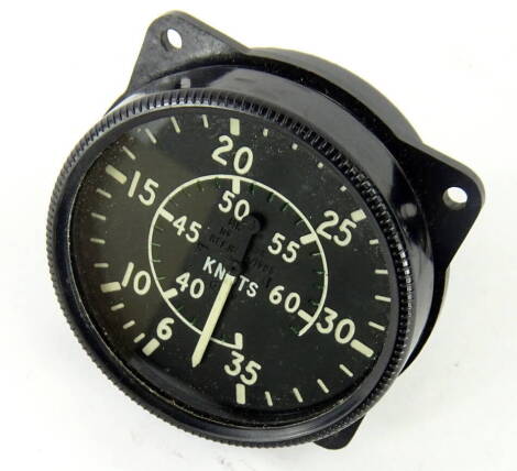 A vintage aeroplane knots dial, in shaped casing, with Arabic numerals, 9cm diameter, marked tested 8th July 1956, with crowsfoot and PS emblems.