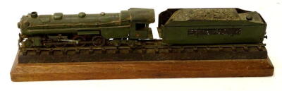 A metal diecast style train model of the Pennsylvanian, in green, on wooden plinth base, 38cm wide, (AF).