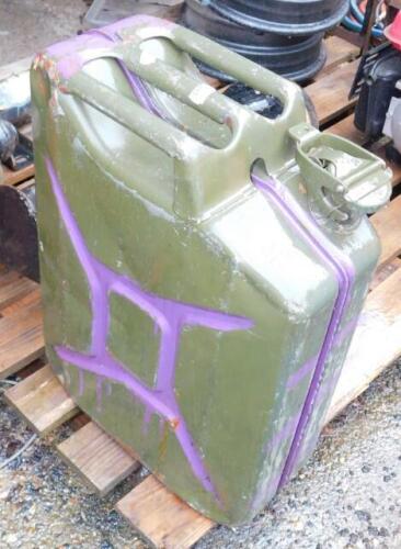 A military jerry can, dated 1987, green with purple over painting.