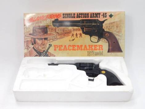 A cowboy toy model of a Peacemaker 1873 Model .45 revolver, blank firing, boxed.