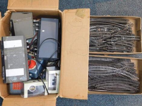 Two boxes of OO-gauge track and points, together with single and twin supply power units. (a quantity)