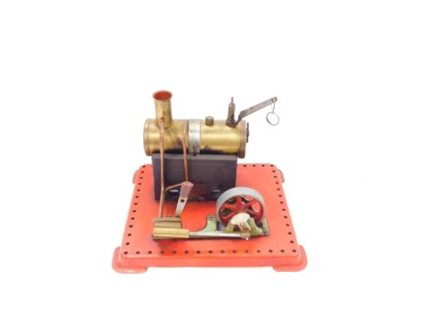 A Mamod stationary engine, the cylindrical brass tank on a painted red base, 20cm high, 21cm wide.