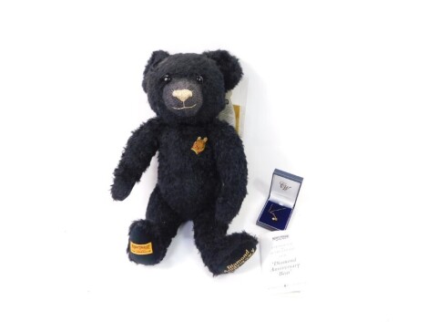 A Merrythought Diamond Anniversary 1930-2005 black plush jointed teddy bear, with label and certificate, 44cm high, with paperwork and cased necklace.