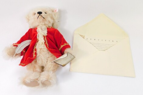 A Steiff musical Mozart plush jointed teddy bear, wearing red jacket, with red label, with paperwork, 26cm high.