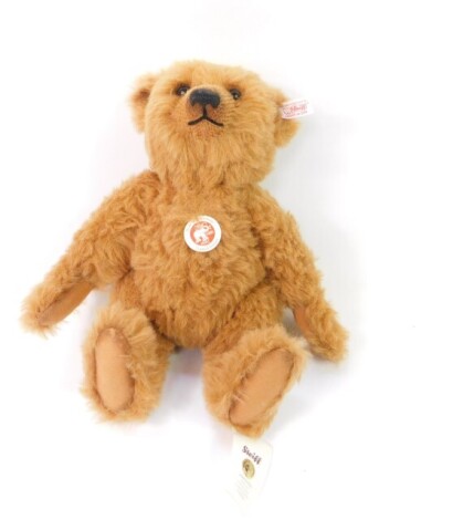 A Steiff plush jointed teddy bear, in brown with growl action, label to the ear, 32cm high.