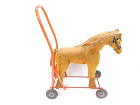 A Tri-ang style push a long horse toy, on a metal frame, 52cm high.