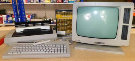 An Amstrad PCW8512 computer, with original packaging marked Boots-W81 Warehouse, Nottingham, boxed, 60cm high.