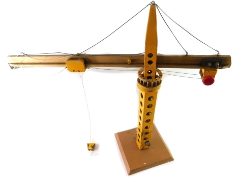 A wooden scratch built model crane, yellow painted, 80cm H.