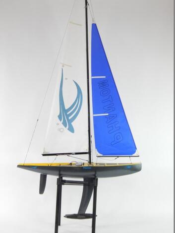 A Hobby King Phantom remote control yacht, yellow and carbon fibre effect hull, 189cm H, 100cm W. (AF)