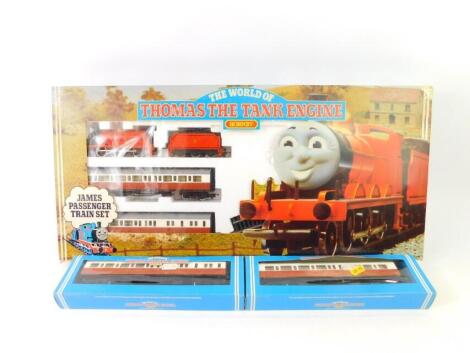 A Hornby OO gauge Thomas The Tank Engine set, comprising James The Red Engine, No 5., two coaches, track and a connecting clip, R094., a James's brake coach, R094, and composite coach, R091, all boxed. (3)