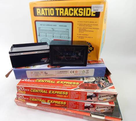 A battery operated 20 piece Moonbow Central Express train set, another, boxed Hattons HA-AB14-004 digital ready six pin locomotive, ratio track side carriage shed, partial Santa's musical train set and a star packed box. (a quantity AF)