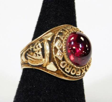 An Oxford University marked ring, with oval red polished stone, size T, marks rubbed, approx 11.6g all in.