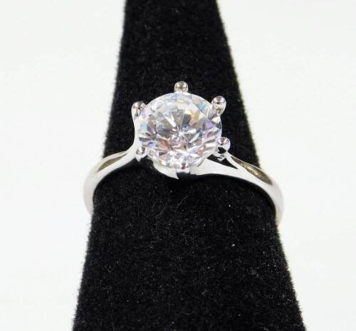 A sterling silver solitaire ring, claw set on plain shank marked 925 CZ, size O.