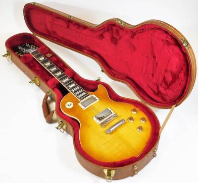 A Gibson Les Paul traditional electric guitar, in honeyburst finish, having twin humbucker pickups, trapezoid inlays and mahogany body, with original Gibson hard shell case.