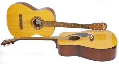 Two acoustic guitars, comprising a Yamaha F310 and an EKO Italian small scale student model.