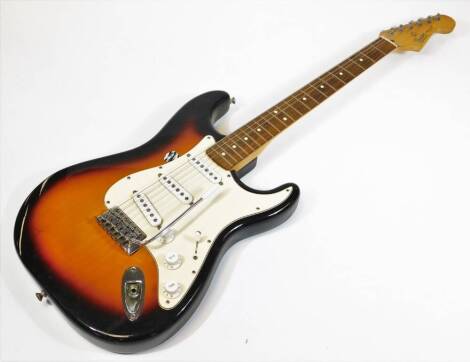 A Fender Stratocaster model electric guitar, made in Mexico, in two colour sunburst finish, having three single coil pickups, with rosewood finger board and clay style dots.