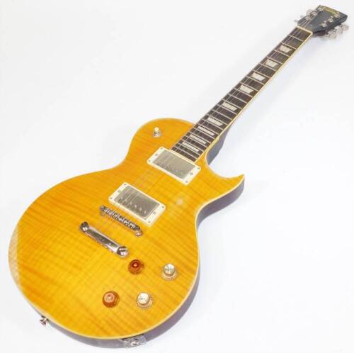 A Vintage brand Les Paul style electric guitar, in honey burst style finish, with relic appearance, with twin Wilkinson humbuckers, trapeze inlaid rosewood finger board.