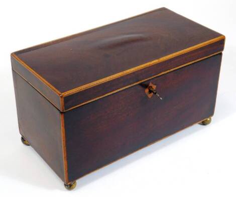 An early 19thC mahogany tea caddy, of rectangular form with shield escutcheon, plain interior and orb feet, 15cm high, 25cm wide, 13cm deep.