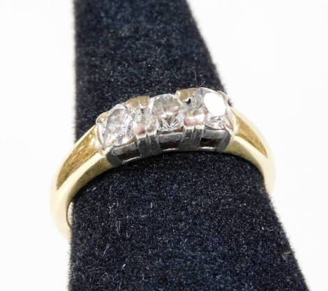 An 18ct gold three stone diamond ring, set with three round brilliant cut diamonds, in platinum setting, each stone approx 0.12cts, ring size O½, 4.7g all in.