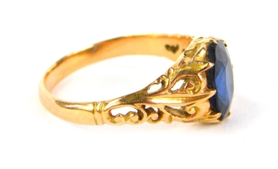 A sapphire set dress ring, with foliate carved shoulders and yellow metal shank, 2.7g all in. - 2