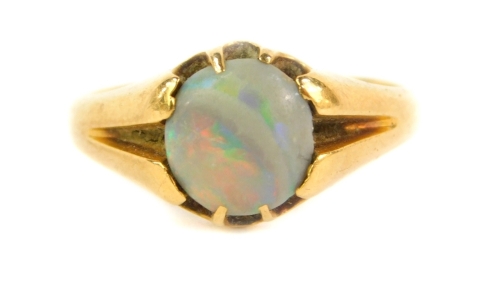 An 18ct gold dress ring, set with a single opal, Birmingham assay, 3.7g all in.