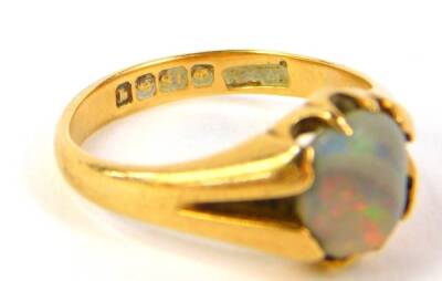 An 18ct gold dress ring, set with a single opal, Birmingham assay, 3.7g all in. - 3