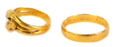 A Victorian gold wedding band with inscription, unhallmarked, 4.5g and an interlinked serpent ring, set with ruby eyes and in a yellow metal shank engraved 22C (2). - 2
