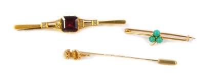 Two bar brooches and a Lincoln Imp stick pin, being one set with three turquoise stones and an Edwardian example set with red and white stones. (3)