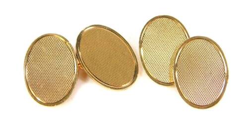 A pair of 9ct gold oval cufflinks, with engine turned decoration, 12.7g.