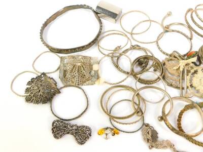 A quantity of mainly Indian and Eastern white metal, including bangles, slave and torc bracelets, chain mail evening purse, etc. - 2