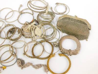 A quantity of mainly Indian and Eastern white metal, including bangles, slave and torc bracelets, chain mail evening purse, etc. - 3