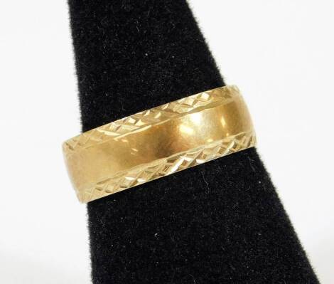 A 9ct gold band, of textured form, size Q, 3.4g.