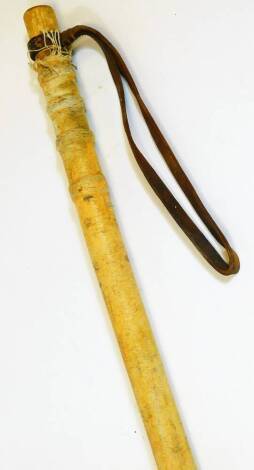 A Japanese cosh or club, of cylindrical form, with turned material body and leather strap handle, possibly WW2, 90cm wide.