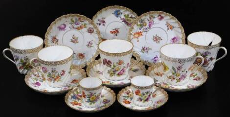 A late 19thC and other Dresden porcelain part service, comprising large cup, small cups and saucers, each with fluted design, polychrome decorated with flowers predominately in green, blue and red with gilt highlights, the saucers 18cm wide, etc., some ma