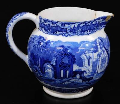 An early 20thC Abbey blue and white pottery jug, of bulbous form with beak spout and plain handle transfer printed with typical scene, 14cm high, an Arcadian blue transfer printed jug and two others. (a quantity) - 2