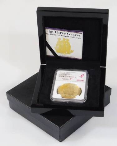 A Three Graces one hundred pound gold coin, with paperwork reading 2015 .999 gold 1oz, in outer case and box.