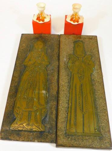 A pair of rectangular brass rubbing plaques, each raised with metal figures in medieval dress and two Palissy squat candlesticks, boxed. (a quantity)