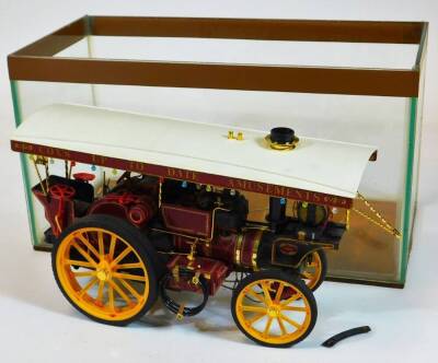 A cased model of a Cox's Upto Date amusement vintage steam tractor, in Perspex case, 23cm high, 42cm wide, 21cm deep.