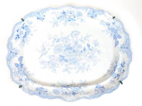 A 19thC Wedgwood and Co blue and white meat plate, of large proportion, with shaped edge, the centre transfer printed with flowers, with impressed and transfer printed marks beneath, 58cm wide.