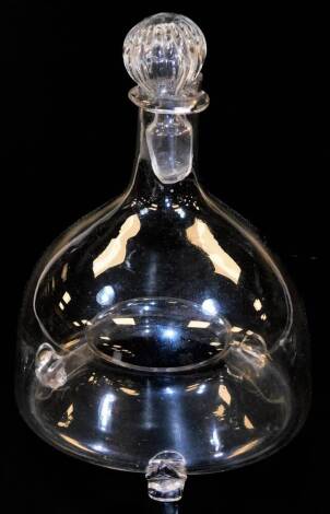 A 19thC glass fly trap jar with stopper, with recess centre section, on shaped feet, 23cm high.