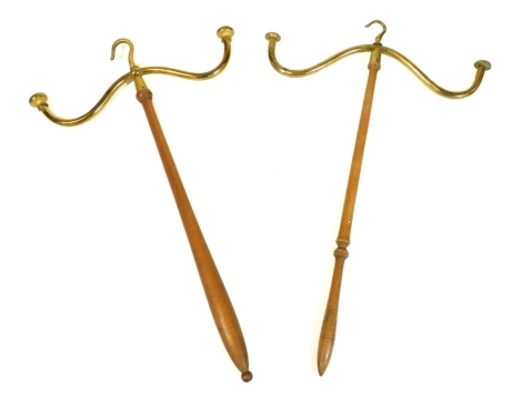 A brass topped wig stand, on turned stem with hook top, 51cm high, and another. (2)