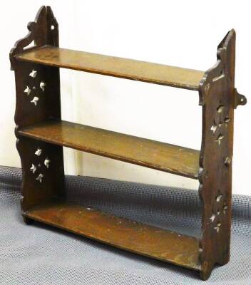 A late Victorian oak hanging shelf, with pierced sides and framed shelves, 50cm high, 60cm wide, 16cm deep.